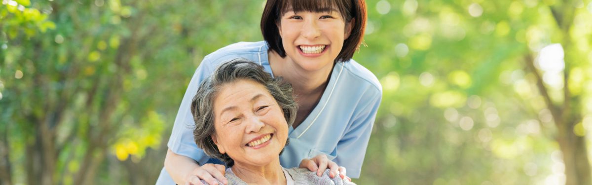 caretaker and elderly woman smiling